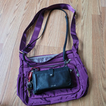Load image into Gallery viewer, Small purse sitting on top of purple bag to show size comparison.
