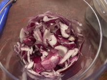 Load image into Gallery viewer, Looking into the clear container to see roughly chopped onions. 
