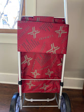 Load image into Gallery viewer, Back of cart, showing how the red back is attached to the cart with a piece of fabric that slides over the silver cart handle.
