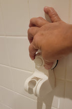 Load image into Gallery viewer, A person&#39;s hand is turning the knob on the shower holder, used to tighten it after pushing the button a number of times.
