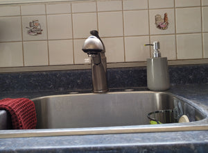 View of sink with sink caddy attached inside of it. It is just visible on the right-hand side.