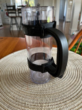 Load image into Gallery viewer, Another angle of the black handle attached to a clear tumbler. 
