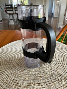 Another angle of the black handle attached to a clear tumbler. 