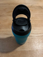 Load image into Gallery viewer, Top view of mug with the lid flipped up/open, revealing the hole to drink out of. 
