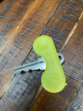 Load image into Gallery viewer, Silver key with a yellow Keywing Key Turner on it, which adds &quot;wings&quot; to the key for easier turning.
