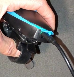 Close-up of charging cable plugged into front light.