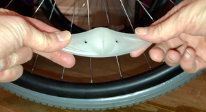 Front of spoke light (not lit up) showing the slit and two small holes on either side.