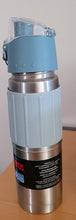 Load image into Gallery viewer, Side view of water bottle, with blue lid and a stainless steel body that has a light blue grip around it with vertical lines.
