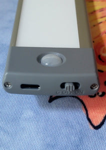 The end of the light strip unit, showing a small on-off switch and a charging port.