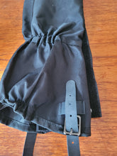 Load image into Gallery viewer, Another angle of the black gaiter and part of its buckle strap.
