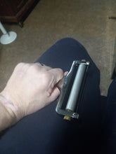 Load image into Gallery viewer, Another view of a person holding the cheese slicer in their hand, with just the metal roller part at the top visible.
