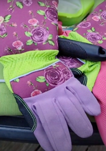 Load image into Gallery viewer, Top of the gloves, which are purple with no visible reinforcement patches except on the side of the thumb. The rose pattern is very visible on the top of the glove and arm
