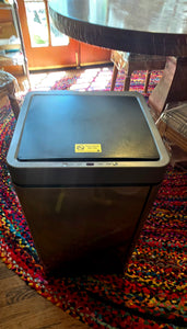 16 gallon, gray, square-shaped motion sensor trash can by Hug&Fkl. There is a small sensor visible on the edge of the trash can and a yellow label.