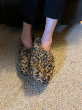 Load image into Gallery viewer, Shaggy leopard slippers on a person&#39;s feet.
