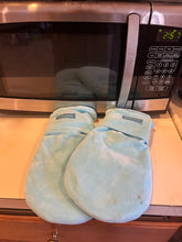 Load image into Gallery viewer, Light blue voligo mitts sitting on a counter in front of a microwave.
