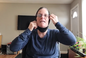 Lisa demonstrates another way of wearing the neck warmer, pulled up over the back of the head so it covers the top of the head and the ears but not the face.