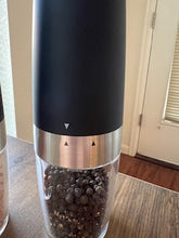 Load image into Gallery viewer, Close up of the arrows on the pepper grinder. Whether the arrows are lined up or not dictates whether the battery compartment can be removed.
