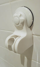 Load image into Gallery viewer, White shower head holder, showing its attachment to the wall and the slot for the shower head handle. The white button is in the middle and the knob around the button is then used to further tighten it.
