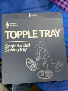 Front of box, reading "Single Handed Topple Tray - Single Handed Serving Tray" with an image of a person swinging a tray with glasses on it.