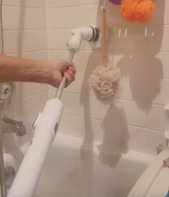 Load image into Gallery viewer, Action shot of Turbo Scrub Power Scrubber, with a hand holding the brush towards the front and the brush scrubbing the tile wall.
