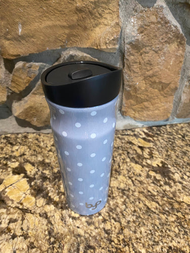Rise Tilt Sip Lid in black with stainless steel water bottle body in gray with white polka dots. 