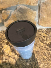 Load image into Gallery viewer, Top down view of the black lid, where there is a large button to slide to open the lid, and an indentation on the lid (hard to see) where you push down to close it.
