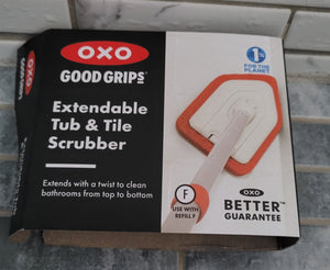 Close-up of the packaging, which shows what the scrubber head looks like and says the name of the product along with "Extends with a twist to clean bathrooms from top to bottom". It also says "OXO Better Guarantee"