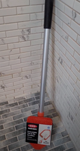 Load image into Gallery viewer, OXO Tub &amp; Tile Scrubber leaning upright in the corner of a tile shower. It has a black grip as the handle, a silver extendable arm, and a red sponge cleaning head shaped like an arrow for corners. The packaging is still on around the scrubber and says &quot;OXO Good Grips Extendable Tub &amp; Tile Scrubber.&quot;
