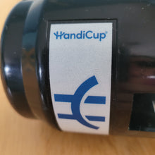 Load image into Gallery viewer, Close-up of the logo on the black HandiCup, which is blue, which a white background and beside it says HandiCup.
