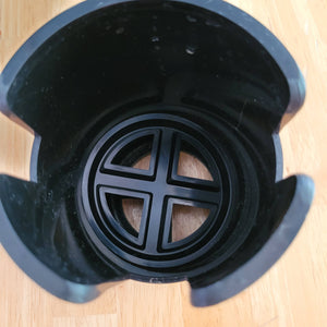 Another top-down view of the cup holder, showing three different slits in the sides, which create space for mug handles. 