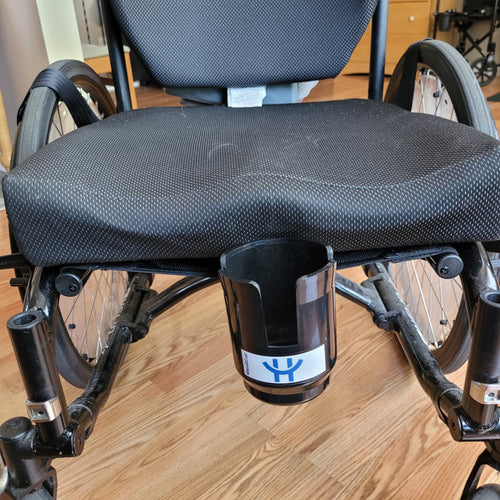 Black wheelchair with black HandiCup cup holder on the front in the middle. The logo on it is blue with a white background.