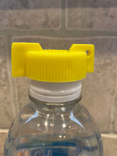 Load image into Gallery viewer, Yellow cap with wings sitting on top of a water bottle cap
