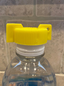 Yellow cap with wings sitting on top of a water bottle cap