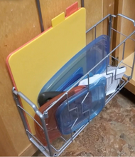 Load image into Gallery viewer, Silver wire organizer hangs on wooden cabinet and is holding cutting boards and tupperware.
