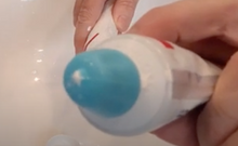 Load image into Gallery viewer, Close-up of blue self closing cap on a toothpaste tube. There is a small bit of toothpaste at the opening.
