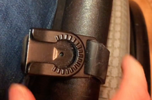 Load image into Gallery viewer, Close-up of the black piece of the phone mount that is attached to the wheelchair. The phone holder has a piece that will slip into this to dock it.
